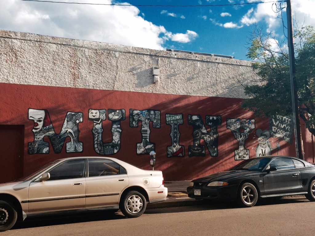 A hand-painted mural on the side of Mutiny Information Cafe. Photo by Meg McIntyre.